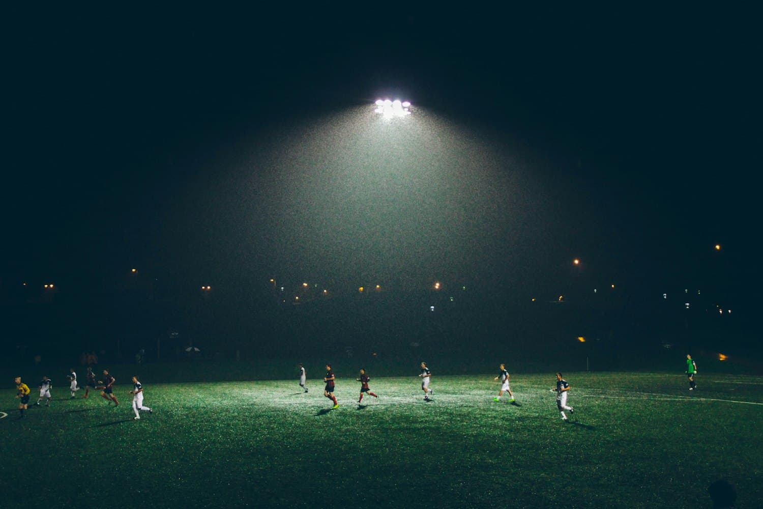 A floodlit football match at night